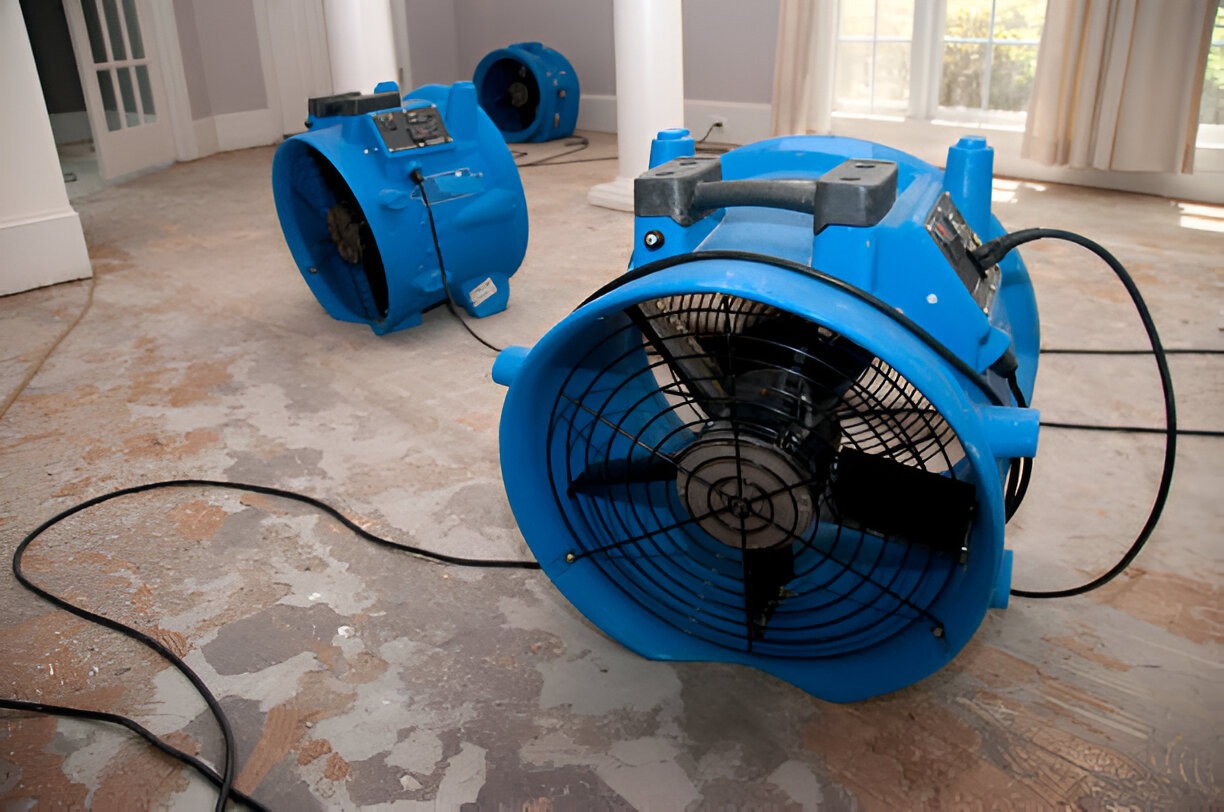 Water damage restoration air movers drying floor